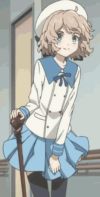 a girl in a blue and white outfit is holding a cane and smiling