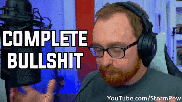 a man wearing headphones and glasses stands in front of a microphone and says complete bullshit