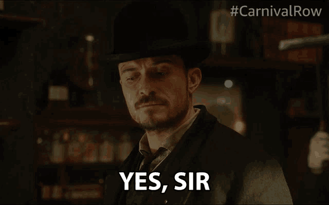 a man in a hat says yes sir in front of a carnival row logo