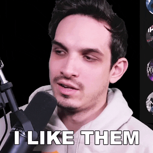 a man in front of a microphone with the words " i like them " below him