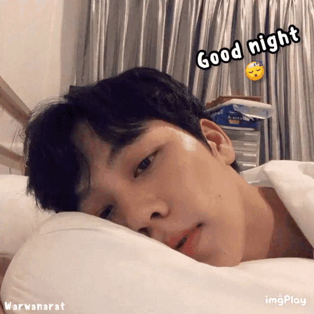 a man is laying on a bed with the words good night written above him