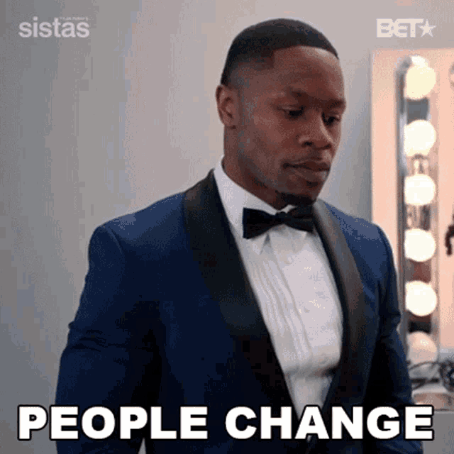 a man in a suit and bow tie says people change .