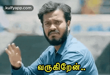 a man with a beard and mustache is making a funny face and waving his hand in tamil .