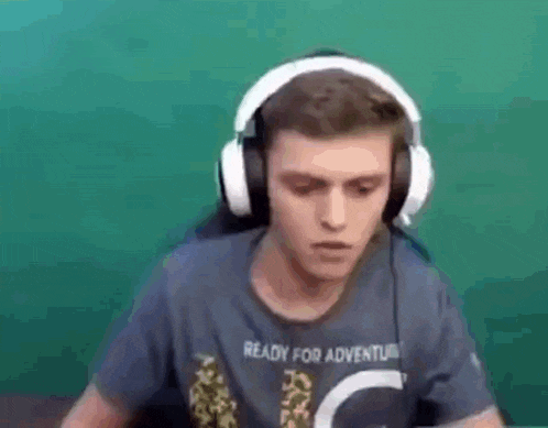 a man wearing headphones and a t-shirt is dancing .