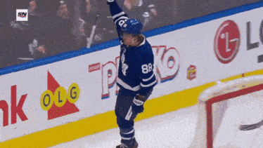 a hockey player with the number 88 on his jersey celebrates a goal