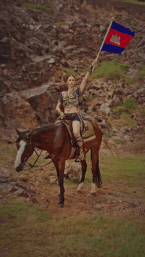 a woman riding a horse holding a flag