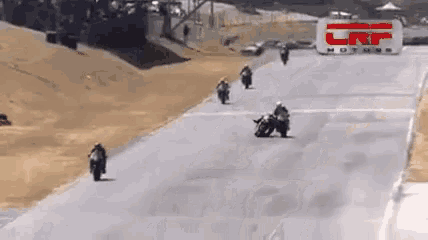 a group of motorcycle racers are racing down a track with a crp motors sign in the background