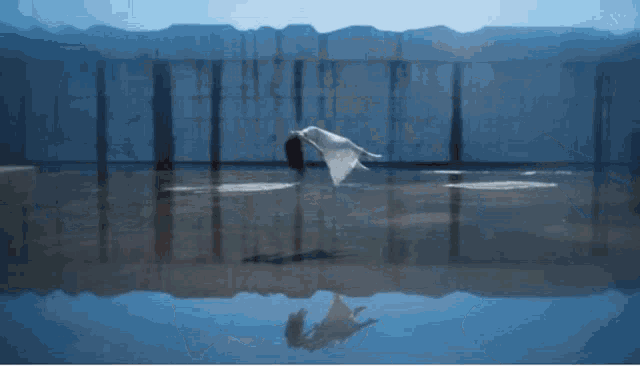 a person is flying through the air in front of a building