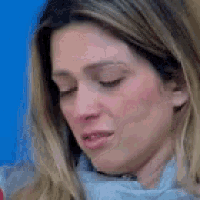 a close up of a woman 's face with her eyes closed against a blue background .
