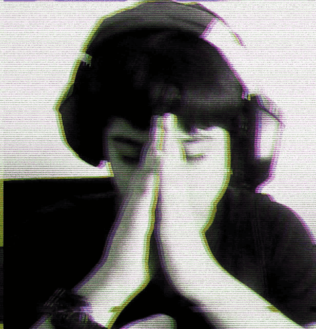 a person covering their face with their hands in a black and white photo