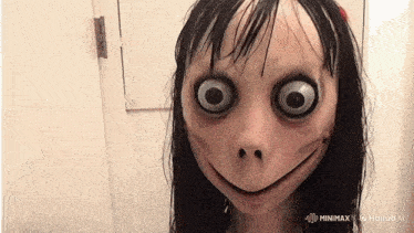 a creepy doll with big eyes and a smile on her face is standing in front of a door .