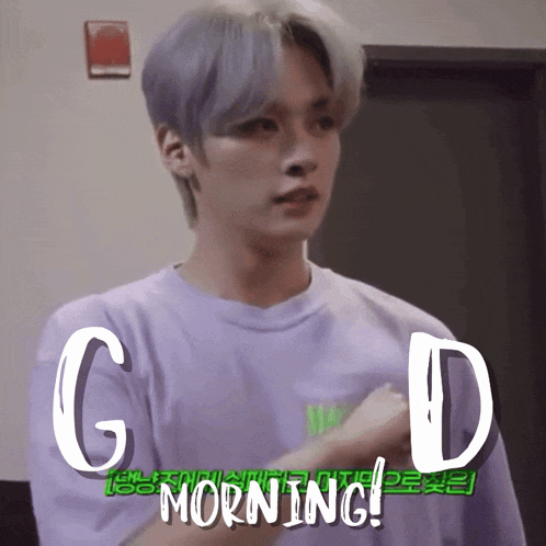 a young man in a purple shirt with the words good morning written on it
