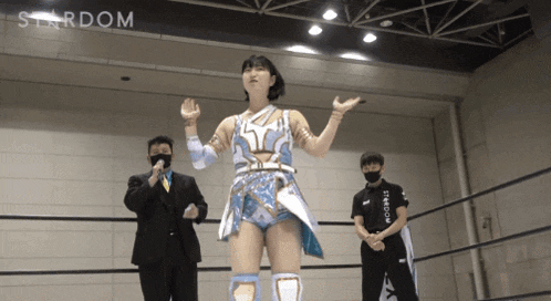 a woman in a wrestling ring with stardom written on the wall