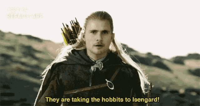 a man with long hair is holding a bow and arrow .