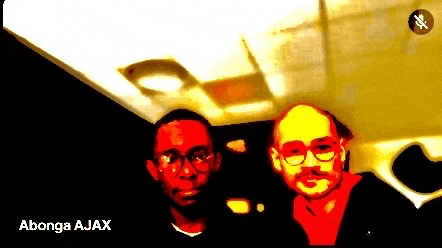 two men are standing next to each other in a dark room with the words " abong ajax " on the bottom