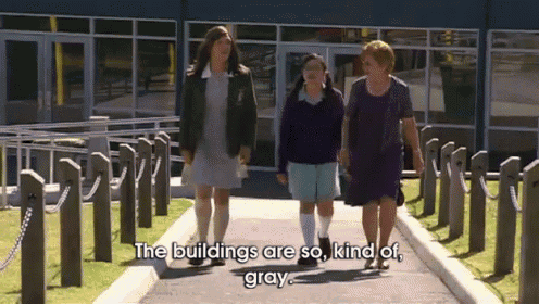 three women are walking down a sidewalk with the words " the buildings are so kind of gray "
