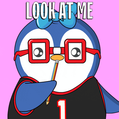 a penguin wearing glasses holds a pencil in its mouth and says look at me