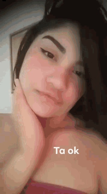 a close up of a woman 's face with the words ta ok written on the bottom