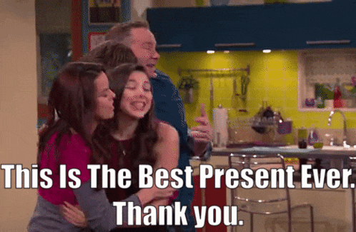 three girls hugging a man in a kitchen with a caption that says this is the best present ever thank you