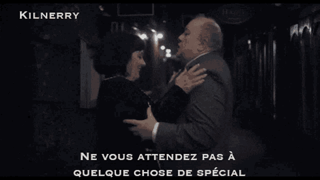 a man in a suit is talking to a woman with the word kilnerry on the top
