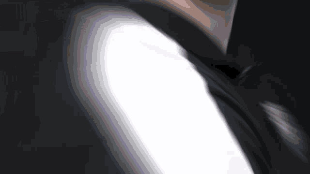 a blurred image of a person 's arm with a white stripe on it