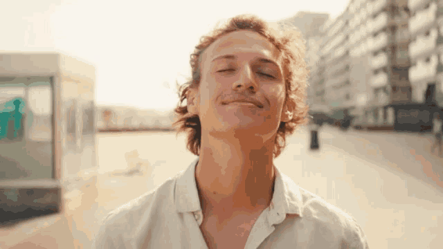 a man with his eyes closed is smiling with his mouth open