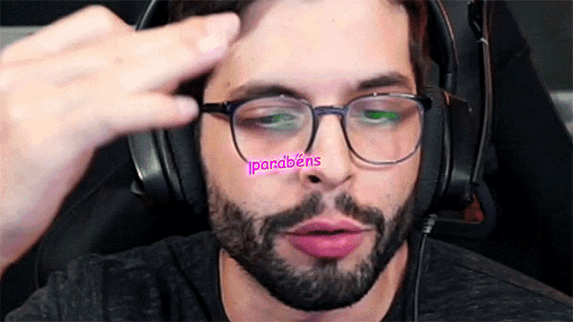 a man wearing glasses and headphones has a pink sticker on his face that says " parabens "