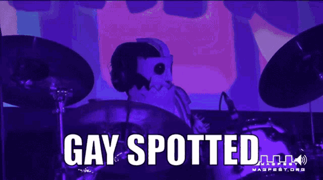 a person playing drums with the words gay spotted in white letters