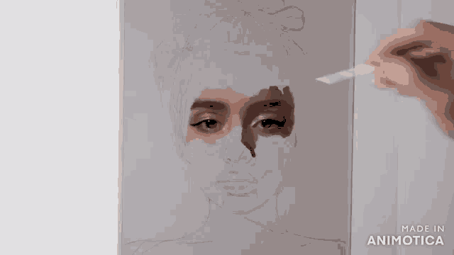 a person is painting a woman 's face with a brush on a piece of paper .
