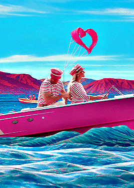 a man and a woman in a pink boat with a heart shaped balloon