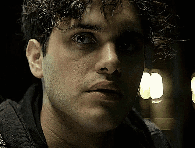 a close up of a man 's face with a blurred background