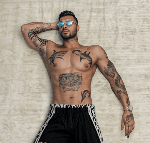a shirtless man with a tattoo on his stomach that says " i love you "