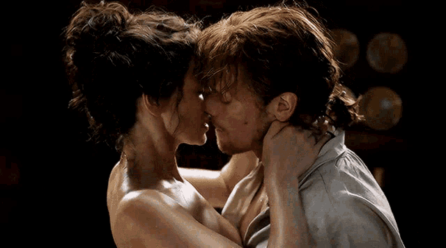 a man and a woman are kissing and the woman has a ring on her finger