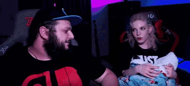 a man and a woman are sitting next to each other in a chair .