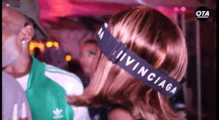 a woman is wearing a headband that says balenciaga on it