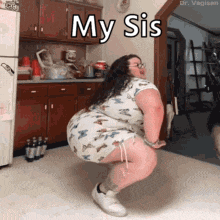 a woman is squatting down in a kitchen with the words " my sis " written above her