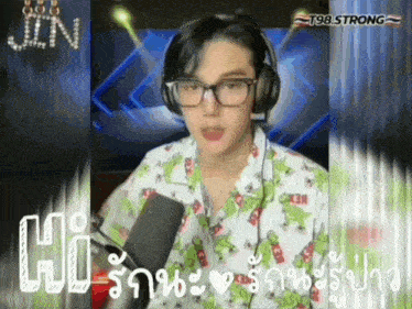 a man wearing glasses and headphones is talking into a microphone