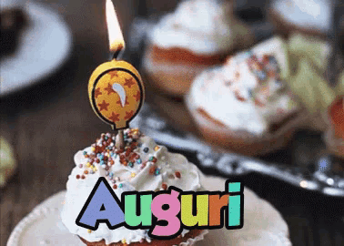 a birthday cupcake with a candle and the word auguri