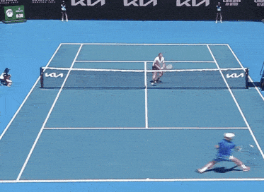 a tennis match is being played on a court that has a kia banner