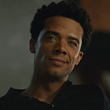 a close up of a man 's face with his eyes looking up