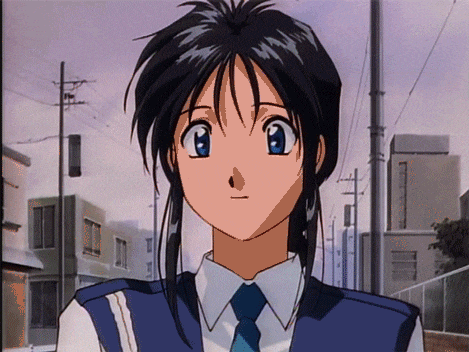 a girl in a blue vest and tie stands in front of a fence