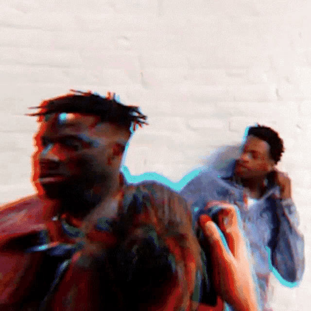 a blurry picture of a man being photographed by another man