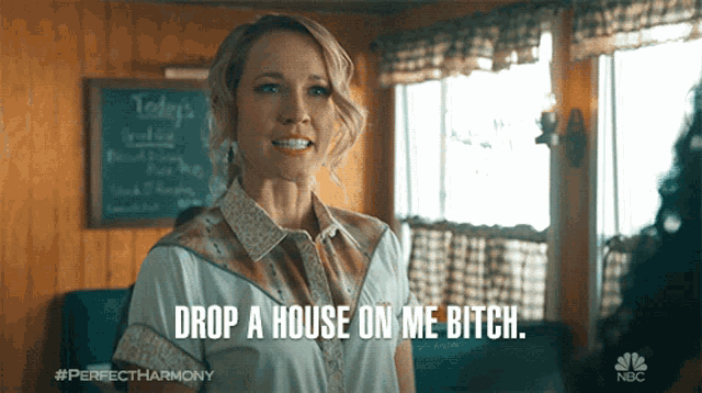 a woman says drop a house on me bitch in front of a chalkboard