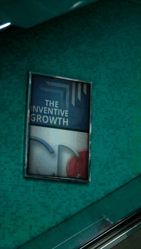 a sign that says the inventive growth on a green wall