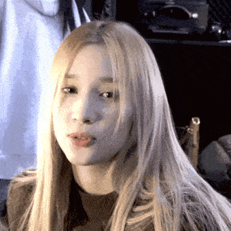 a close up of a woman with long blonde hair