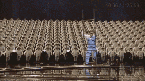 a large group of people are standing in a row and the time is 40 36