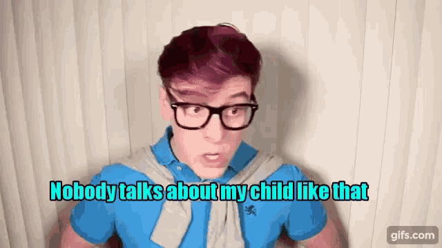 a young man wearing glasses and a blue shirt says " nobody talks about my child like that "