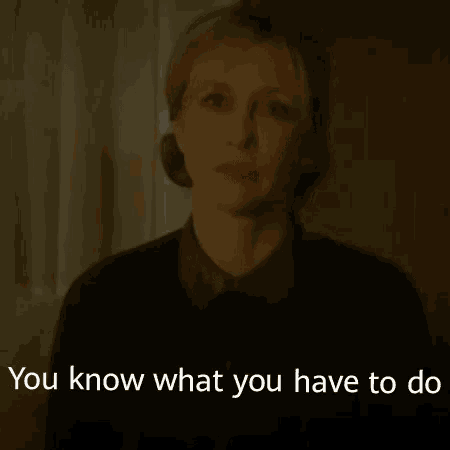 a woman is talking in a dark room and the words `` you know what you have to do '' are visible .