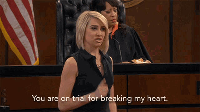 a woman in a courtroom with the words " you are on trial for breaking my heart "