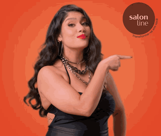 a woman in a black dress is pointing to a salon line logo